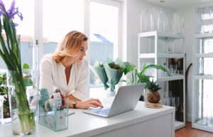 florist using laptop in flower shop